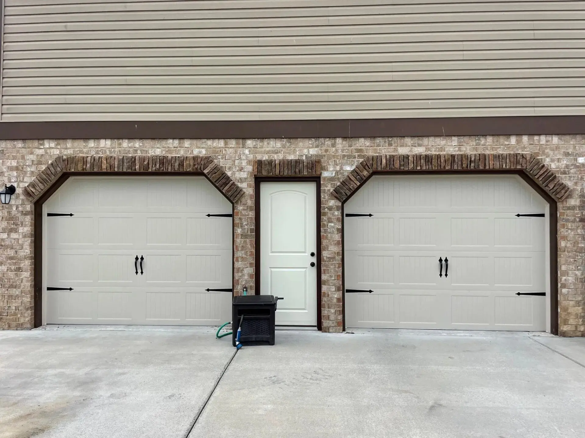 Two white garage doors installation